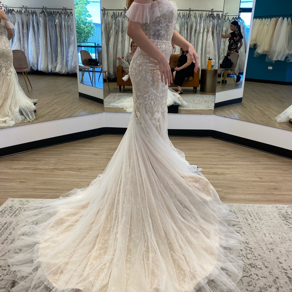 Wedding gown, one of a kind. Never worn. Comes with matching vail.